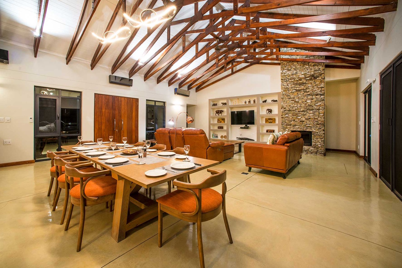 Open-plan dining area at night with beamed ceiling