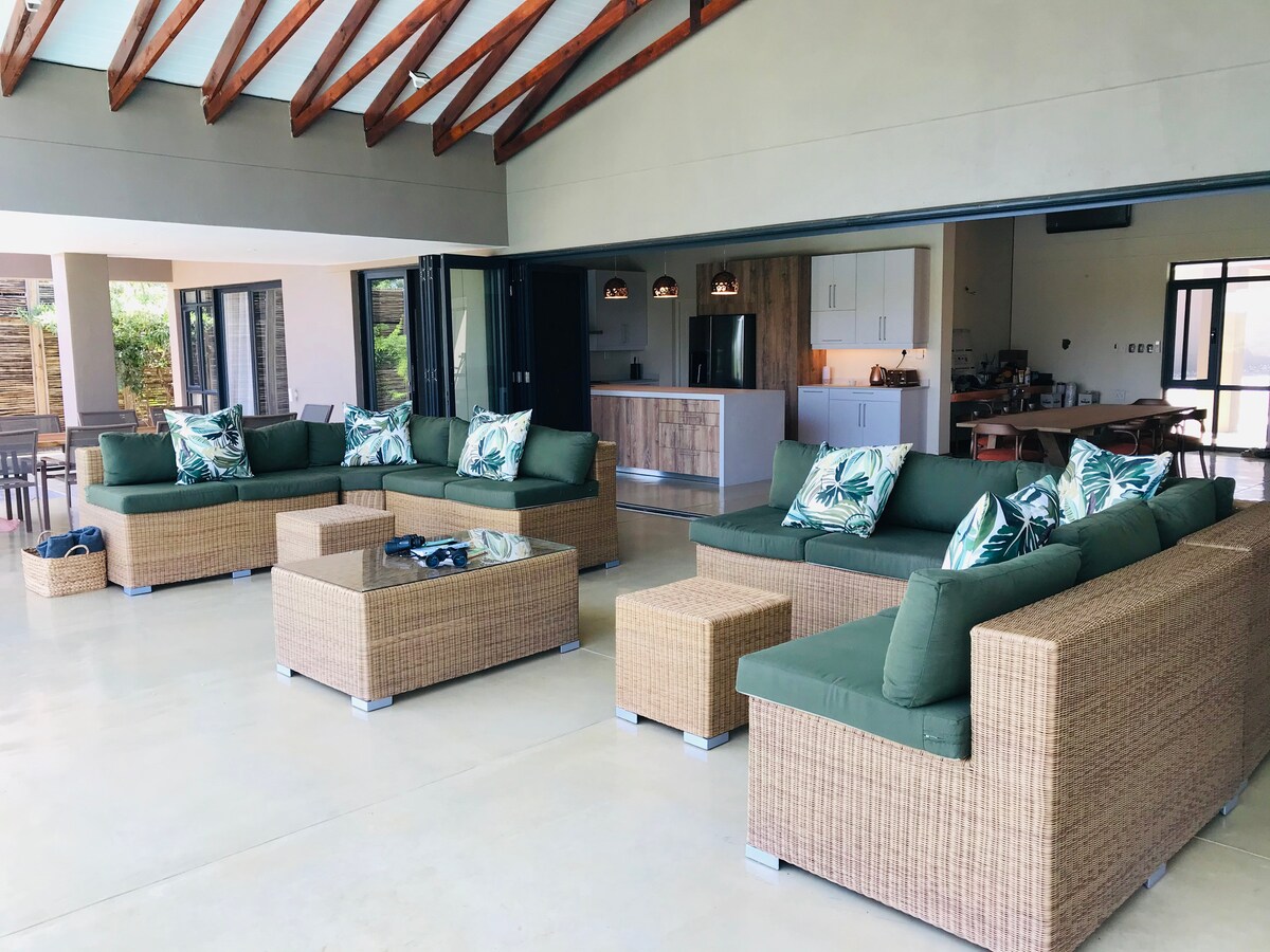 Lounge with green furnishings and natural light